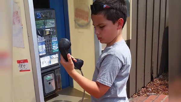 Kid sees pay phone for the time & has no idea what it is!